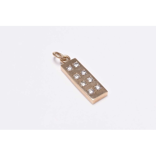 44 - A 9ct gold diamond set ingot pendant, the rectangular yellow gold ingot set with eight round brillia... 