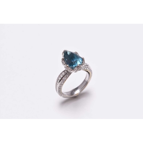 50 - An 18ct white gold blue zircon and diamond ring by Kat Florence, designed as a central pear cut blue... 
