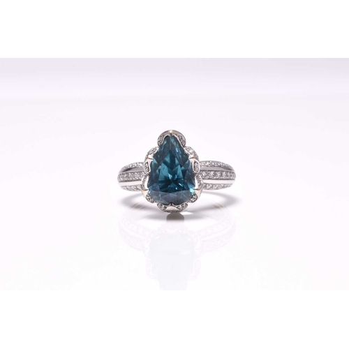 50 - An 18ct white gold blue zircon and diamond ring by Kat Florence, designed as a central pear cut blue... 