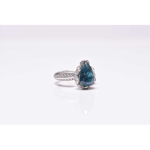 50 - An 18ct white gold blue zircon and diamond ring by Kat Florence, designed as a central pear cut blue... 