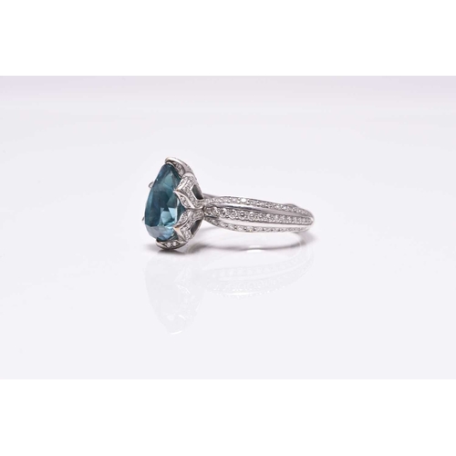 50 - An 18ct white gold blue zircon and diamond ring by Kat Florence, designed as a central pear cut blue... 
