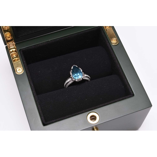 50 - An 18ct white gold blue zircon and diamond ring by Kat Florence, designed as a central pear cut blue... 