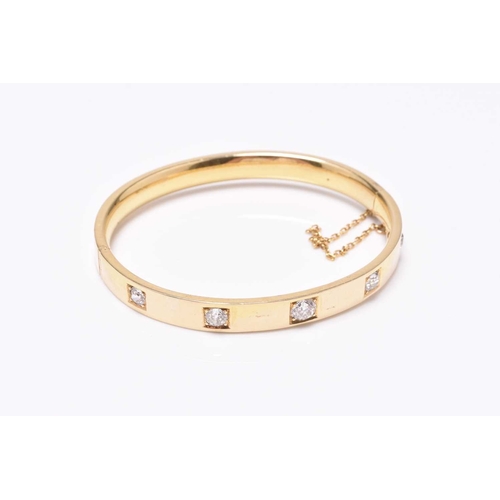 55 - A diamond set hinged bangle, the five old cut diamonds claw and box set in yellow metal with integra... 