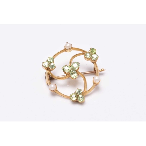 56 - A circular split pearl and green stone openwork brooch, designed as a central green stone cluster su... 