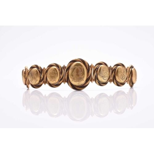 60 - A 19th century woven hair graduated locket bracelet, designed as seven yellow metal oval graduated l... 