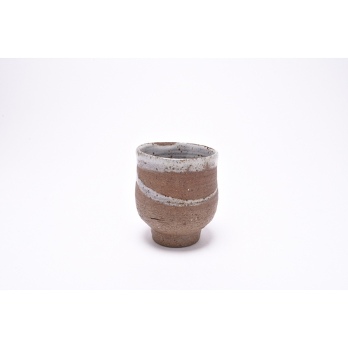 109 - Janet Leach (1918-1997), St Ives Pottery, a studio pottery yunomi vessel, circa 1980/81, the dry red... 