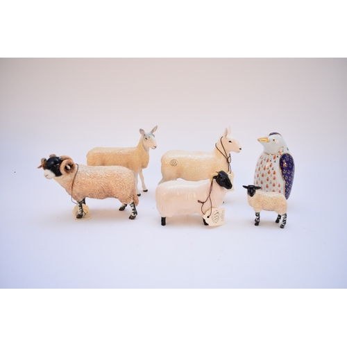 127 - A collection of Beswick animals, comprising nine hunting hounds, five black-faced rams and four lamb... 