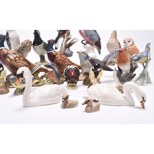 132 - A group of models of birds, comprising Beswick birds: a Lesser Spotted Woodpecker, a Thrush, a Lapwi... 