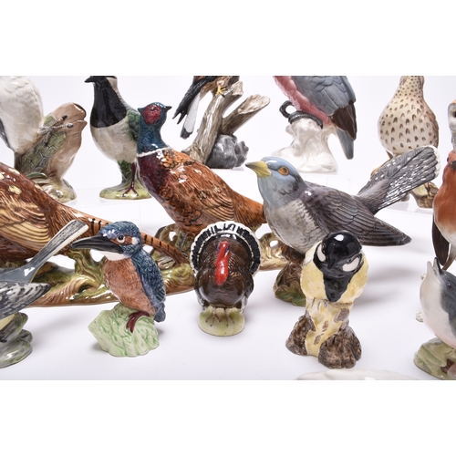 132 - A group of models of birds, comprising Beswick birds: a Lesser Spotted Woodpecker, a Thrush, a Lapwi... 