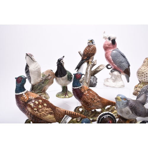 132 - A group of models of birds, comprising Beswick birds: a Lesser Spotted Woodpecker, a Thrush, a Lapwi... 