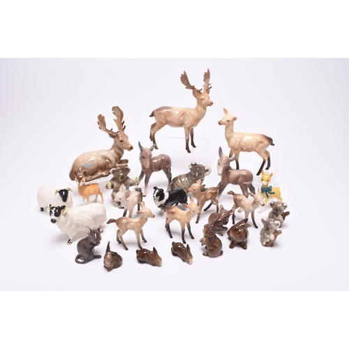 133 - A collection of Beswick models of animals, comprising two sheep and a dog, two mice, a donkey, a fam... 