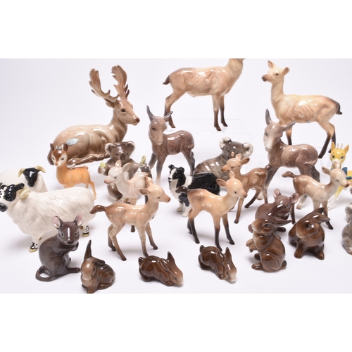 133 - A collection of Beswick models of animals, comprising two sheep and a dog, two mice, a donkey, a fam... 