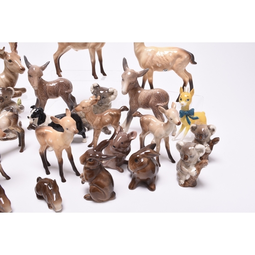 133 - A collection of Beswick models of animals, comprising two sheep and a dog, two mice, a donkey, a fam... 