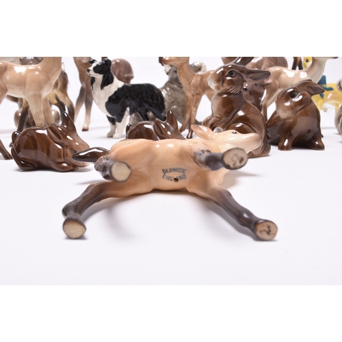 133 - A collection of Beswick models of animals, comprising two sheep and a dog, two mice, a donkey, a fam... 