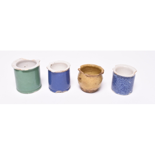 14 - Four ointment pots, early 19th century, comprising three tin-glaze examples, one green, one blue and... 