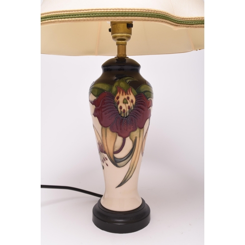 209 - A Moorcroft 'Anna Lily' table lamp, 21st century, with original Moorcroft shade, of tall, slender fo... 