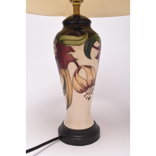 209 - A Moorcroft 'Anna Lily' table lamp, 21st century, with original Moorcroft shade, of tall, slender fo... 