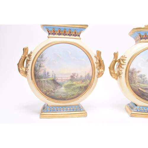 216 - A pair of French porcelain moon flask vases, late 19th century, of twin-handled form, nicely decorat... 