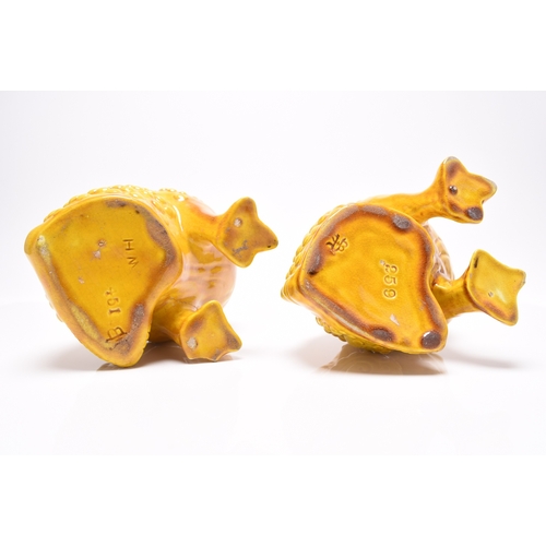 22 - A pair of Burmantofts faience grotesque spoon warmers in the form of toads, circa 1885-90, pale ochr... 