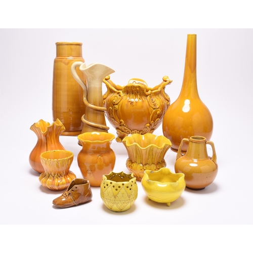 44 - A small group of bright yellow or mustard English art pottery, late 19th century, comprising a small... 