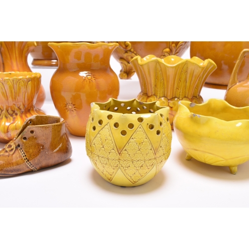 44 - A small group of bright yellow or mustard English art pottery, late 19th century, comprising a small... 