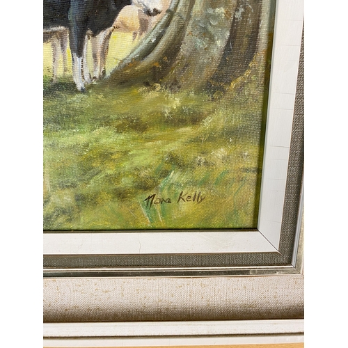 448 - Nora Kelly (Irish 20th Century) Cows grazing around a tree, signed lower right, oil on canvas, 35 x ... 