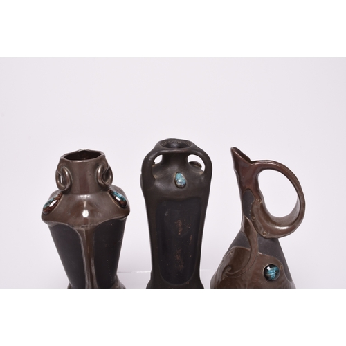 47 - A collection of seven Bretby Art Nouveau Pottery vases, circa 1900, of bronzed organic form decorate... 