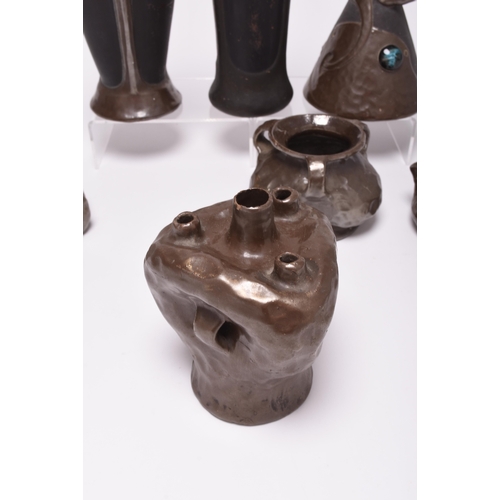 47 - A collection of seven Bretby Art Nouveau Pottery vases, circa 1900, of bronzed organic form decorate... 