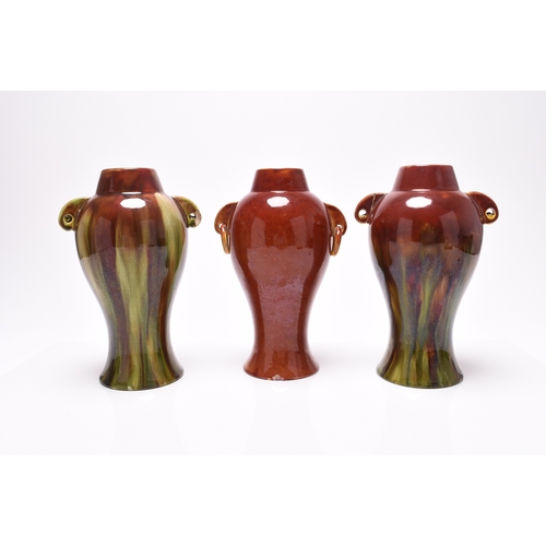 55 - Three similar Burmantofts faience vases, late 19th century with red and steaked green glazes, with t... 