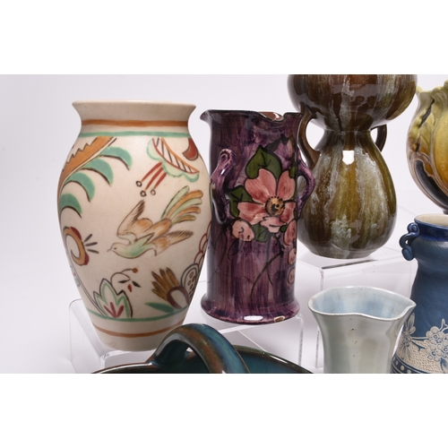 59 - A collection of British art pottery, circa 1880-1930, including a group of C H Brannam (Barnstaple):... 