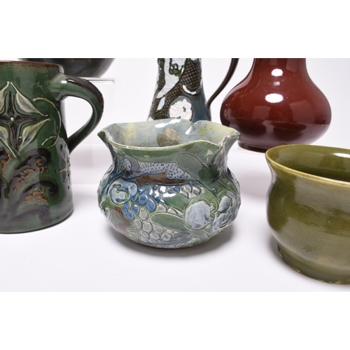 59 - A collection of British art pottery, circa 1880-1930, including a group of C H Brannam (Barnstaple):... 