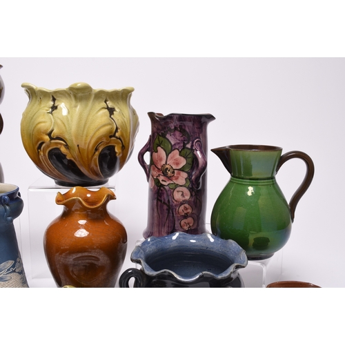 59 - A collection of British art pottery, circa 1880-1930, including a group of C H Brannam (Barnstaple):... 