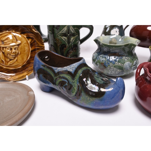 59 - A collection of British art pottery, circa 1880-1930, including a group of C H Brannam (Barnstaple):... 