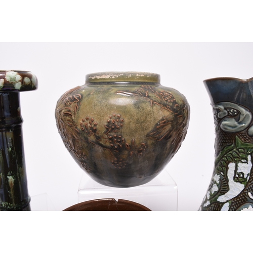 59 - A collection of British art pottery, circa 1880-1930, including a group of C H Brannam (Barnstaple):... 