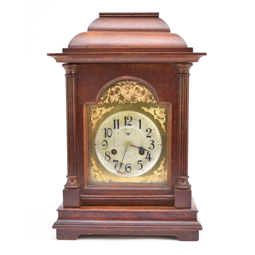 599 - A German oak cased bracket clock, early 20th century Of typical form, the brass arched dial with sil... 