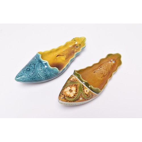 60 - Two Linthorpe art pottery wall pockets in the form of slippers, circa 1885, one with a turquoise ext... 