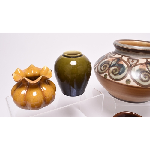 61 - A collection of Linthorpe art pottery, late 19th century, including a small mustard glaze vase, shap... 