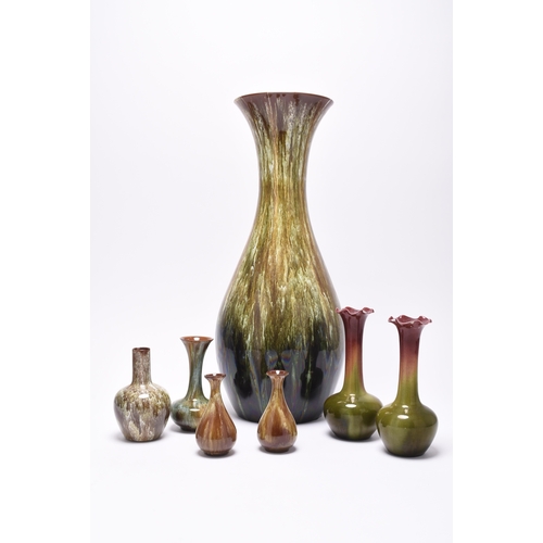 62 - A small group of art pottery, comprising three Linthorpe art pottery vases, circa 1890, covered in s... 