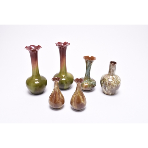 62 - A small group of art pottery, comprising three Linthorpe art pottery vases, circa 1890, covered in s... 