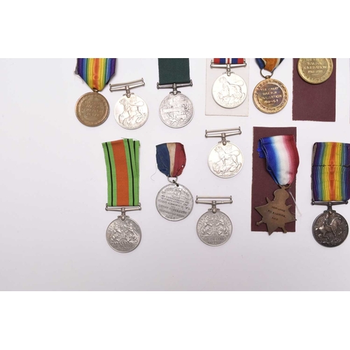 137 - A group of assorted medals, comprising three 1939-45 War Medals, two Defence Medals, a WW1 pair of 1... 