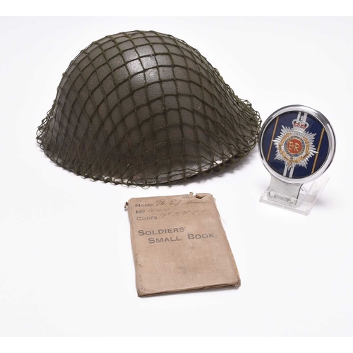 74 - An assembled group of militaria to include: A British Army MKIV helmet dated 1979, with exterior net... 