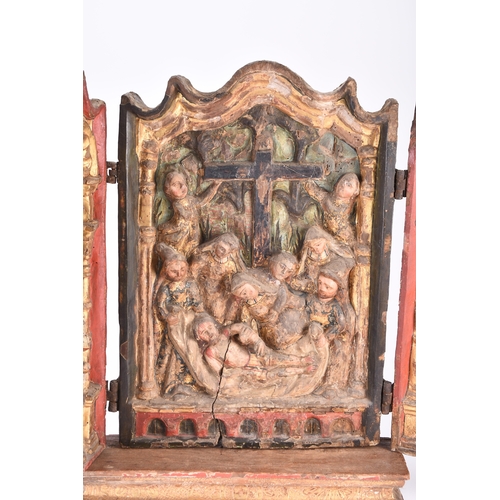 145 - A 17th century polychrome and parcel gilt gesso and carved wood triptych Portuguese or Spanish The c... 