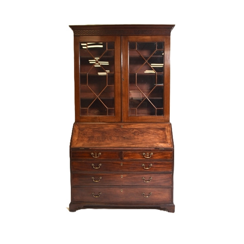 188 - A George III mahogany bureau bookcase The dentil cornice above a blind fretwork frieze and twin astr... 