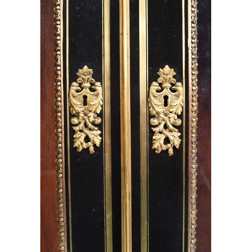 213 - A Louis XVI style ebonised and gilt-metal mounted pier cabinet With twin glazed doors enclosing thre... 