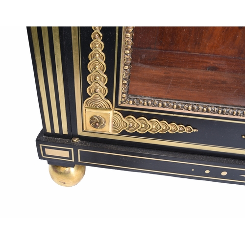 213 - A Louis XVI style ebonised and gilt-metal mounted pier cabinet With twin glazed doors enclosing thre... 