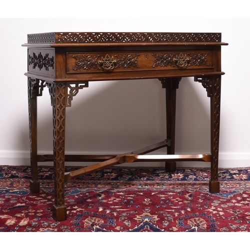 219 - A reproduction mahogany silver table in the Chippendale style The pierced gallery top above a single... 