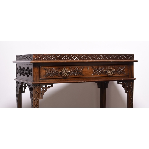 219 - A reproduction mahogany silver table in the Chippendale style The pierced gallery top above a single... 