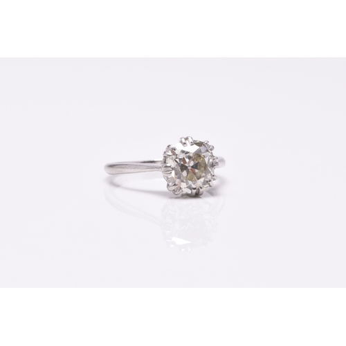 23 - A single stone diamond ring, the cushion cut diamond claw set in white metal to white metal shank, s... 