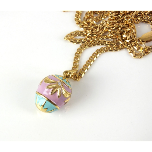 24 - A diamond and enamel egg pendant on chain, the pink and green enamelled egg set with four brilliant ... 