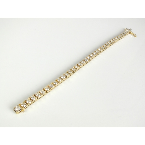 32 - A 9ct gold diamond set tennis bracelet, the thirty-six brilliant diamonds claw set in yellow gold, w... 